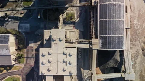Aerial view tracks across large cement plant, with CEMEX supplied as commercial Stock Footage 346464982