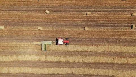 Aerial view of tractor baling hay in a field, Serbia. Stock Footage 339630940