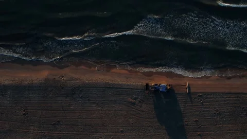 Aerial View of Tractor Cleaning Sand on Beach at Sunset Video stock 344529256