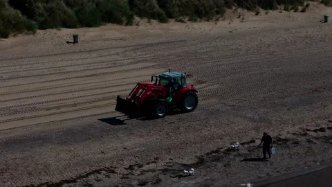 Aerial View, Tractor Clearing Sandy Beach during Summer Maintenance Stock-Footage 345489688