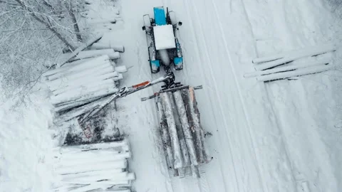 Aerial view tractor with a crane loads a trailer with logs. Top view Stock Footage 169548535
