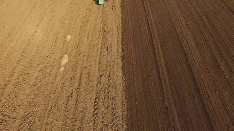 Aerial view of a tractor cultivating a fields with black soil for planting in 4K 库存影片 74143939