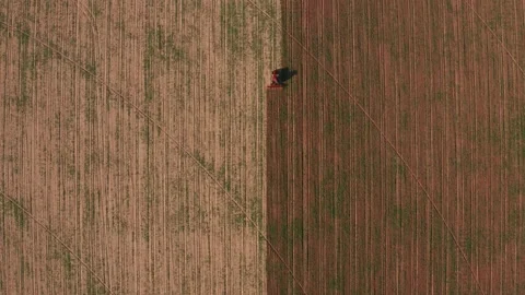 Aerial view tractor cuts furrows in farm field for sowing farm tractor with Stock Footage 145519712