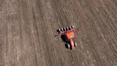 Aerial view tractor cuts furrows in farm field for sowing Stock Footage 243156840