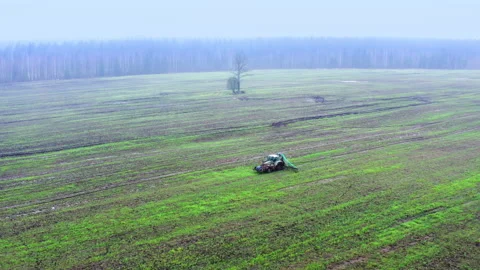 Aerial view. The tractor drives through the field. Autumn work in agriculture. Stock Footage 221268659