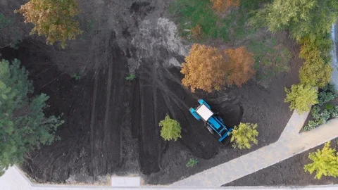 Aerial view tractor grinding work using a bucket in the park. land improvement Stock Footage 120442955
