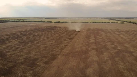 Aerial view of tractor with harrows working on field cultivating dry soil Stock Footage 120197690