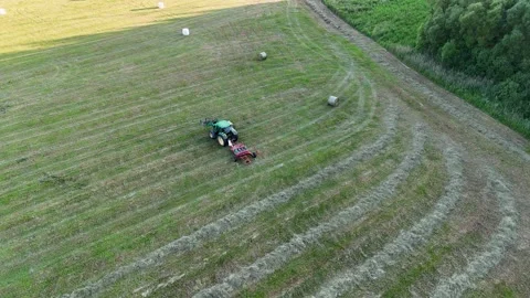 Aerial View of Tractor in Hayfield Stock Footage 298910392
