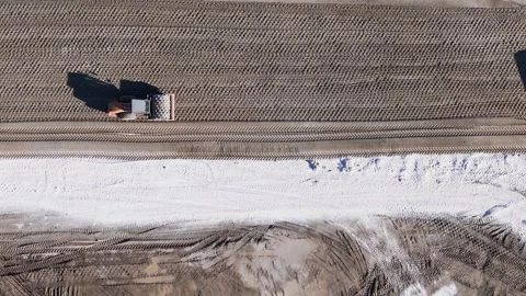 Aerial view of a tractor leveling a construction site with distinct earth and Video stock 281333771