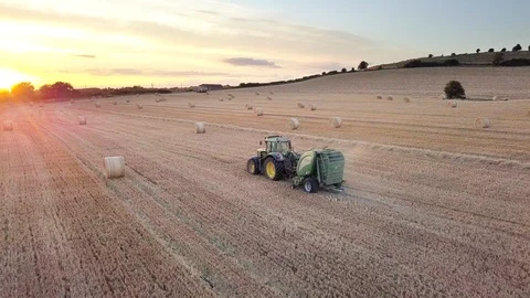 Aerial view of tractor making hay bales Stock Footage 92999322