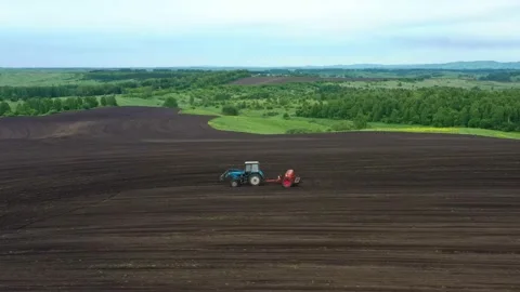 Aerial view of tractor with mounted seeder performing direct seeding. Stock Footage 226322448