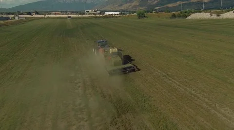 Aerial view of tractor picking up hay Stock Footage 41540342