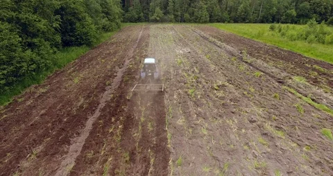Aerial view of the tractor plowing a field Drone footage Stock Footage 91674650