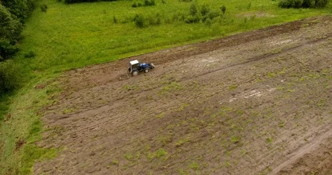 Aerial view of the tractor plowing a field Drone footage Video stock 91744959