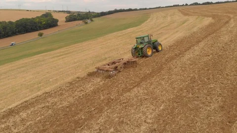 Aerial view of tractor plowing a field Stock Footage 95325854