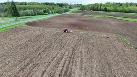 Aerial View of Tractor Plowing a Field Stock Footage 318953224