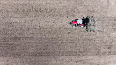 Aerial view of tractor plowing field, France. Stock Footage 332704700