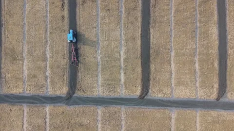 Aerial view of tractor plowing field in Sweden. Stock Footage 345073733
