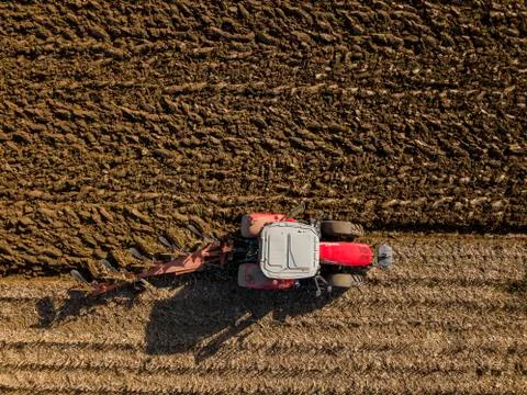 Aerial view, Tractor plowing fields, preparing land for sowing Stock Photos