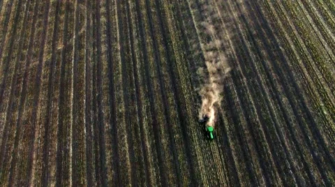 Aerial view of tractor plowing the soil on sunset Stock Footage 60699891
