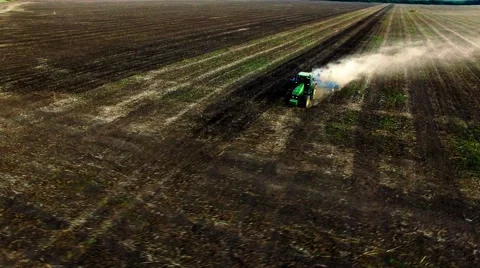 Aerial view of tractor plowing the soil on sunset Stock Footage 60700246