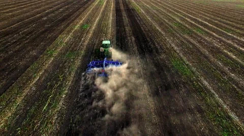 Aerial view of tractor plowing the soil on sunset Stock Footage 60700288