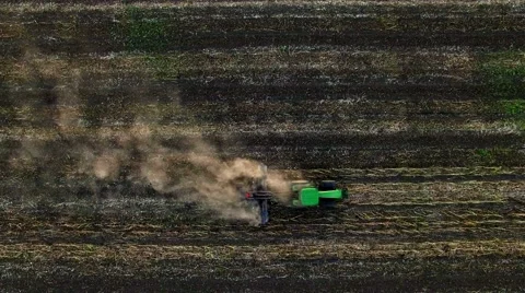 Aerial view of tractor plowing the soil on sunset Stock Footage 60700543