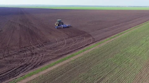 Aerial view of tractor plowing the soil on a fertile field Video stock 62249935