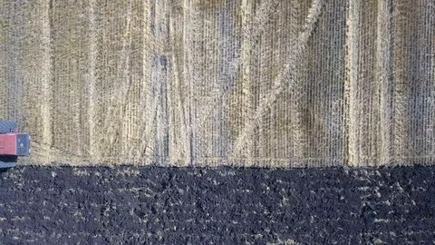 Aerial view of a tractor plows a field. Video stock 112712875
