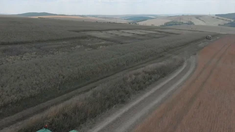 Aerial view of tractor pulling a machine behind Stock Footage 95326807