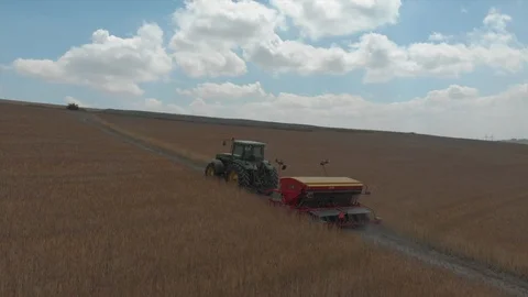 Aerial view of tractor pulling a machine behind Stock Footage 95326973