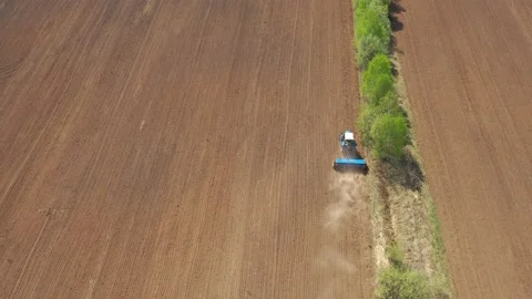 Aerial view of the tractor seeding the field with a special seeder Stock Footage 160125421