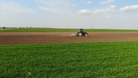 Aerial view of tractor seeding Stock Footage 130636657