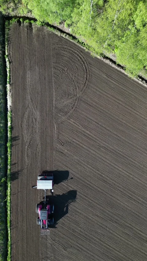 Aerial view of tractor seeding with mounted seeder Stock-Footage 310777949