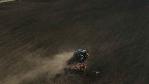Aerial view of a tractor sowing on a field Stock Footage 134374265