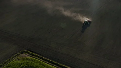 Aerial view of a tractor sowing on a field Stock Footage 134375129