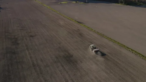 Aerial view of a tractor sowing on a field Stock Footage 134382676