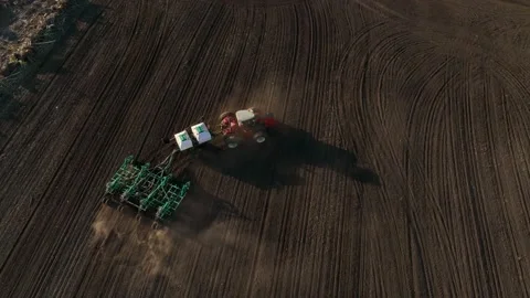 Aerial View Tractor Sowing Seed On Plowed Field In Spring. Farming And Seeding Stock Footage 232118445