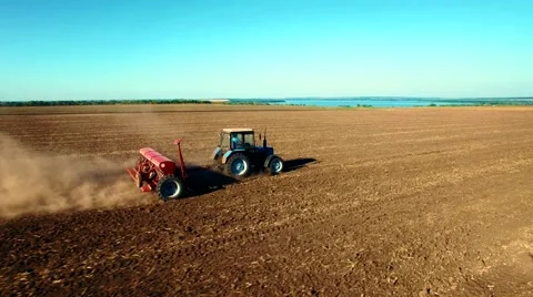 Aerial view of tractor sowing wheat Stock Footage 60699682