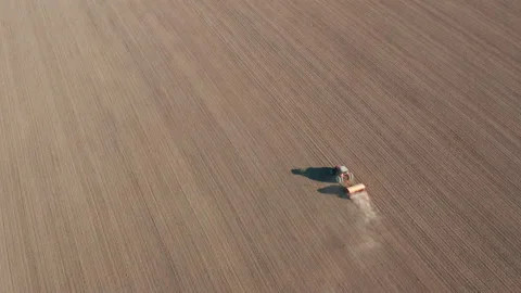 Aerial view of a tractor sowing a wheat field in spring Stock Footage 176367000