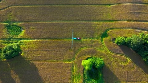 Aerial view of tractor spraying crops in field using long booms for agricultural Stock Footage 345716360