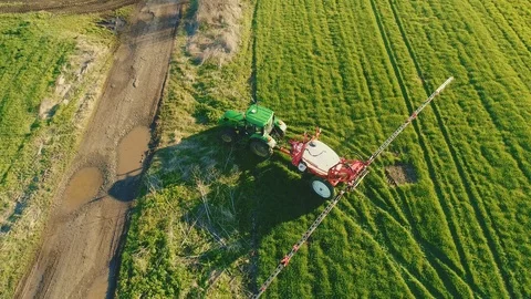 Aerial view of a tractor spraying the field. Chemistry in agriculture Stock Footage 127383814