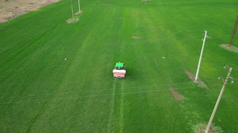 Aerial view of a tractor spraying the field.  Stock Footage 264342811