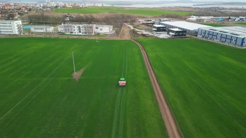 Aerial view of a tractor spraying the field.  Stock Footage 264342841