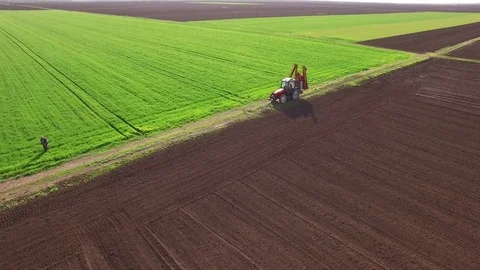 Aerial view of tractor spraying wheat field Video stock 72609930