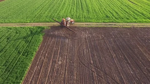 Aerial view of tractor spraying wheat field Video stock 72610440