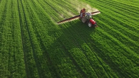 Aerial view of tractor spraying wheat field Stock-Footage 72612077