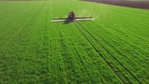 Aerial view of tractor spraying wheat field Stock-Footage 72612682