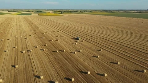 Aerial view of tractor tow trailed bale machine to collect straw Stock Footage 300245211
