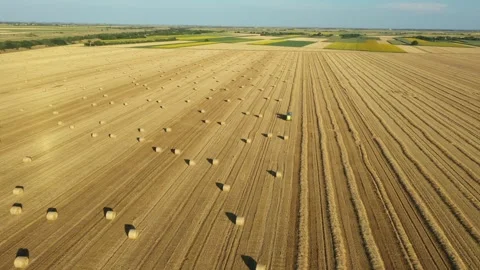 Aerial view of tractor tow trailed bale machine to collect straw Stock Footage 300245255